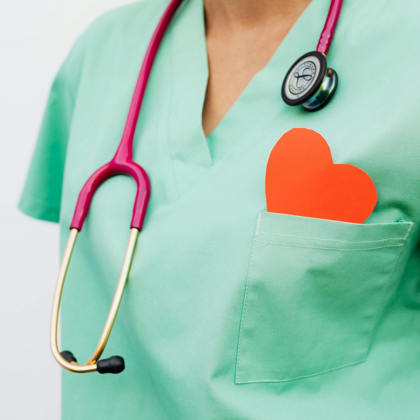 A healthcare professional with a stethoscope and red heart symbol emphasizes cardiology care.